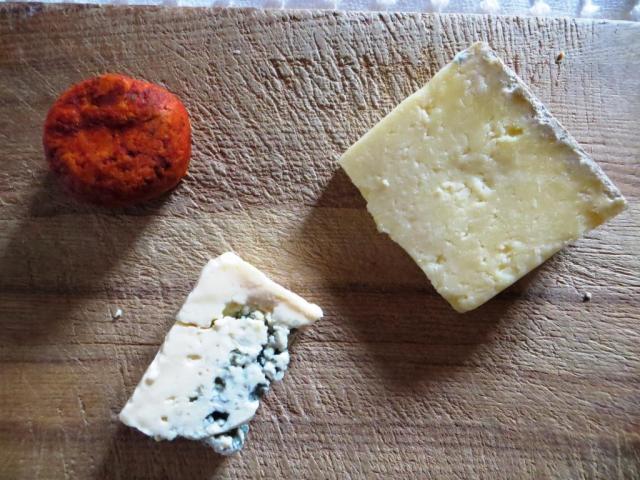 The remnants of last night's cheese board: Maroilles coated in paprika, Laguiole and Bleu d'Auvergne